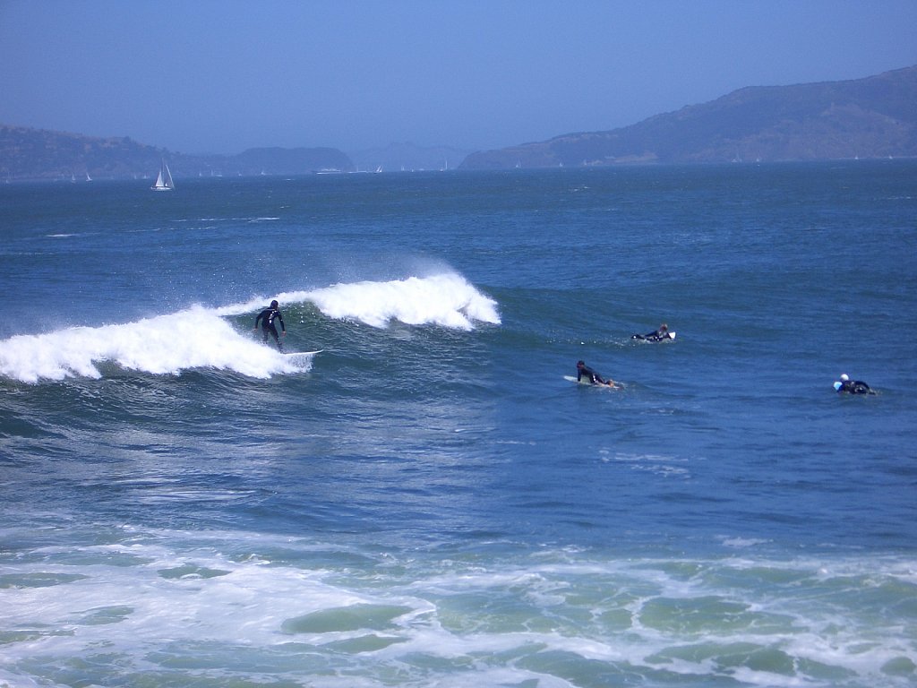 Surfers near the Golden Gate Bridge