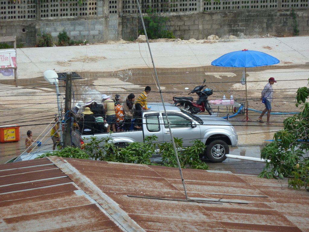 A truck load of people getting prepared for the next water fight