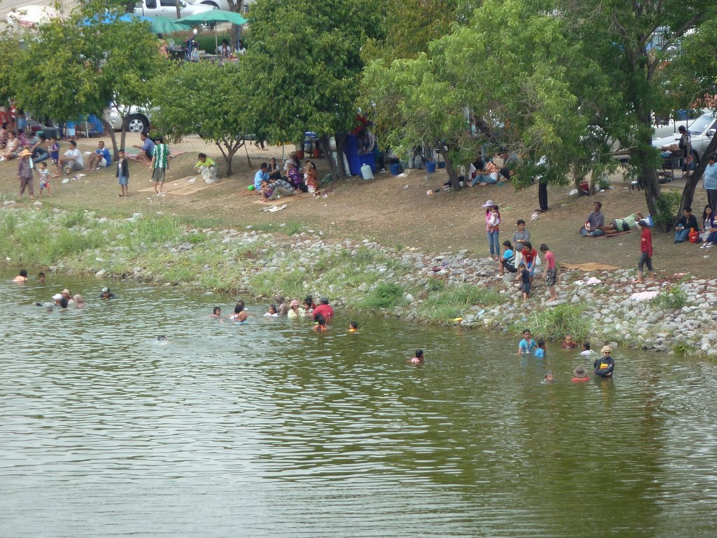 People bathing in lake in Nong Prajak Park