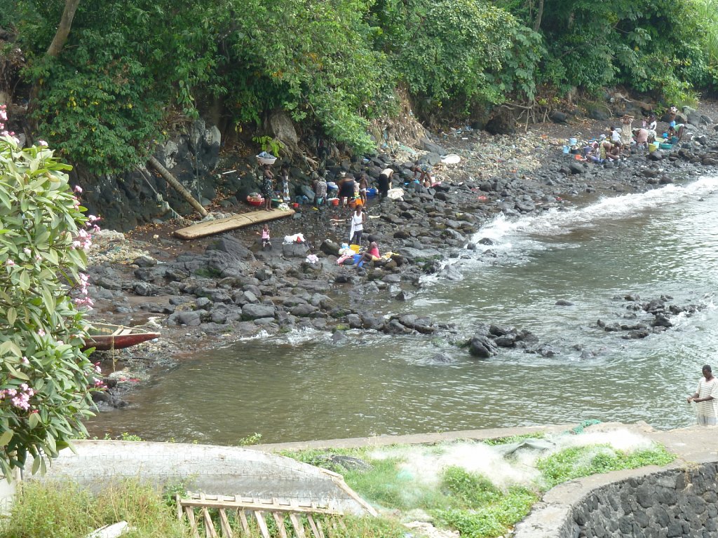 Women washing clothes at the beach