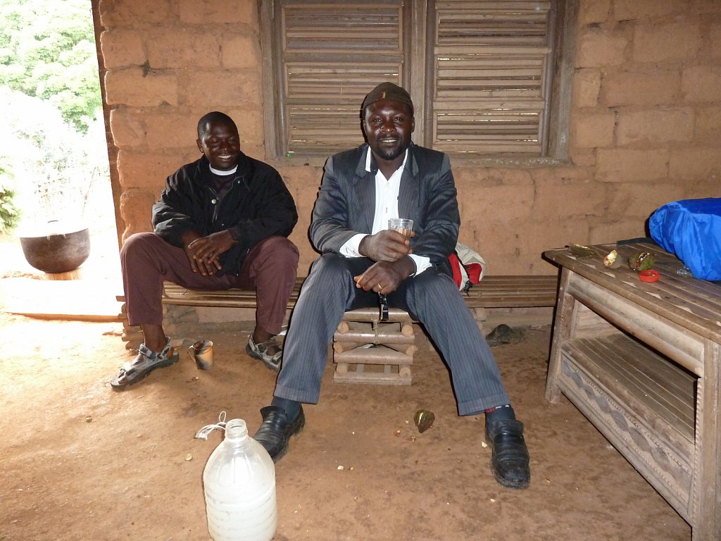 Drinking palm wine in a traditional house