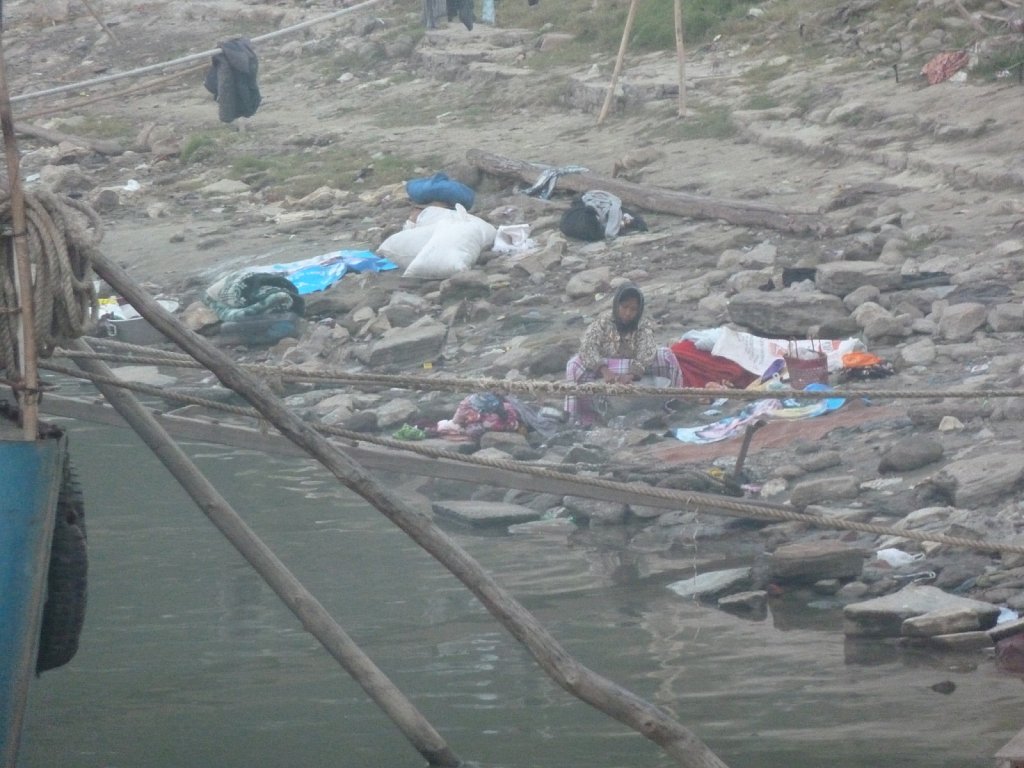 Woman washing clothes on the bank of the Irrawaddy river