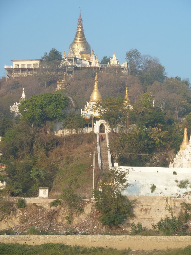 Monk on the stairway to a stupa