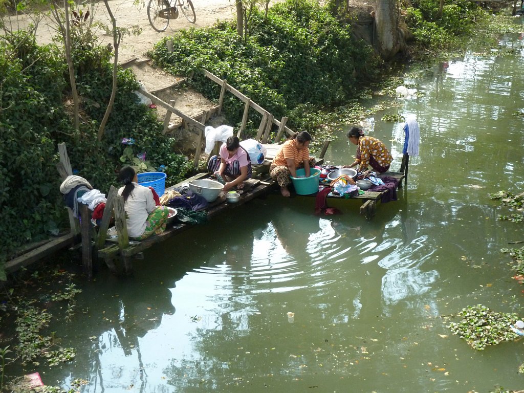 Women doing laundry at a stream