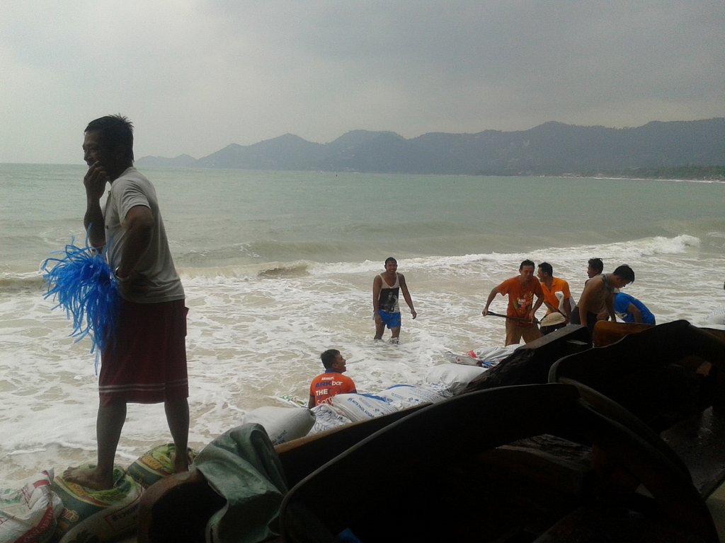 Employees protecting hotel against rough sea